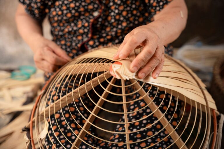 Hands finishing a handwoven basket